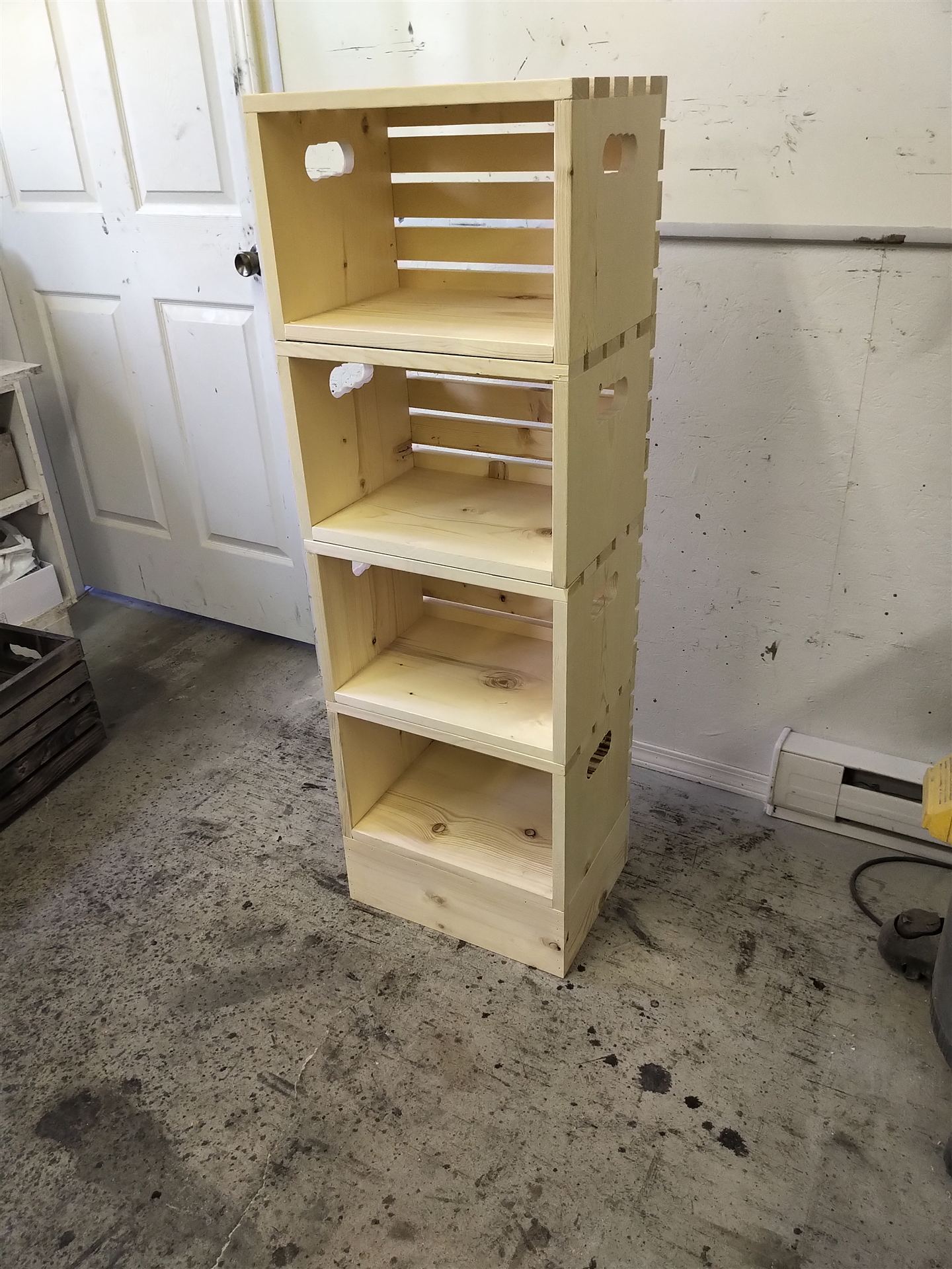 Row of pine crates with peaked lids and cutout handles