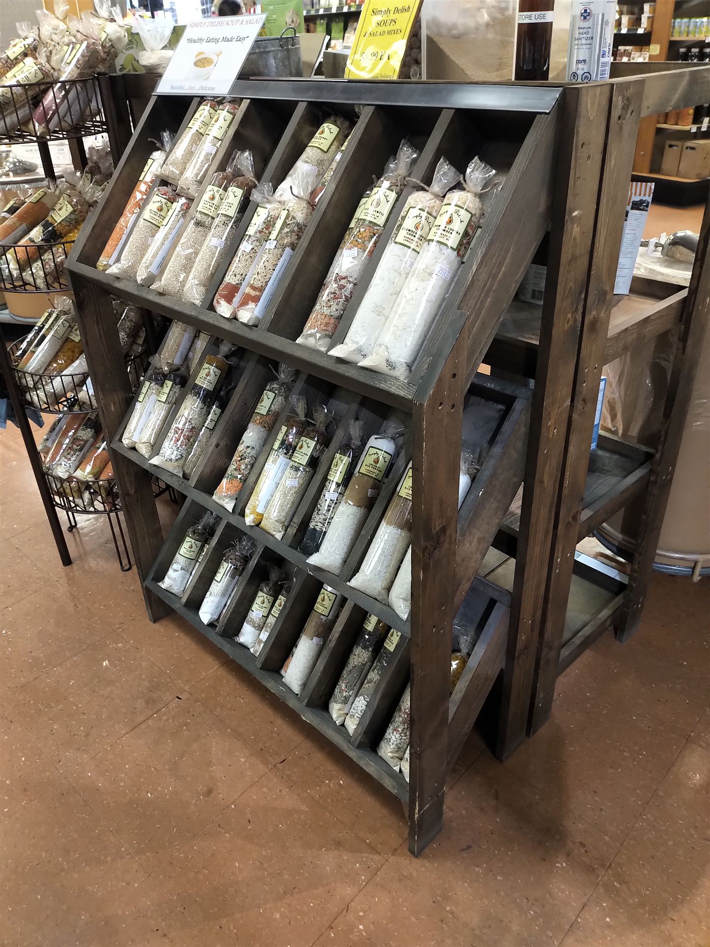 Stained pine retail display shelving stocked with bulk grain